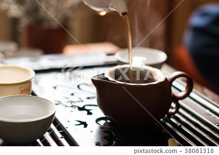 Pouring of Puer Tea from Teapot at Traditional Pouring of Puer Tea from Teapot at Traditional 38081318