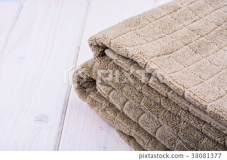 Terry towels brown on wooden table 38081377