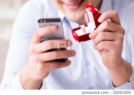 Young man chatting with his sweetheart over mobile 38083908