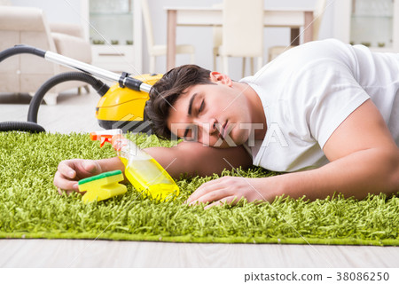 Young husband man cleaning floor at home 38086250