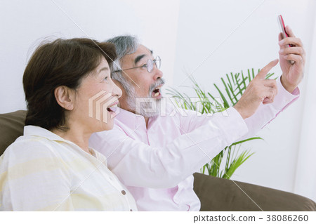 A bright retirement image Senior couple who takes self-taking with a smartphone A bright retirement image Senior couple who takes self-taking with a smartphone 38086260
