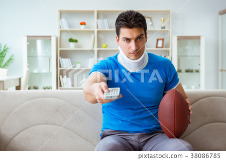 Man with neck injury watching american football at Man with neck injury watching american football at 38086785