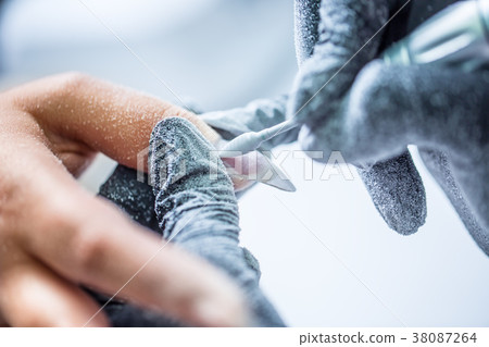 Repairing old gel nails with a nail grinder. Repairing old gel nails with a nail grinder. 38087264