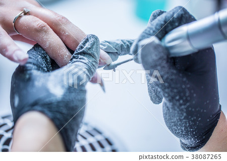 Repairing old gel nails with a nail grinder. Repairing old gel nails with a nail grinder. 38087265