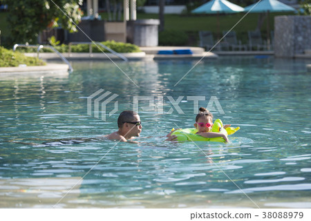 Parent and child playing in the pool Parent and child playing in the pool 38088979