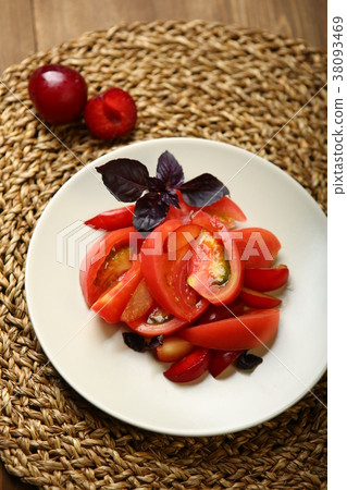 Salad of tomato and red plums with basil for a 38093469