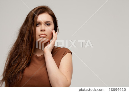 Plus size fashion model in brown short dress Plus size fashion model in brown short dress 38094610