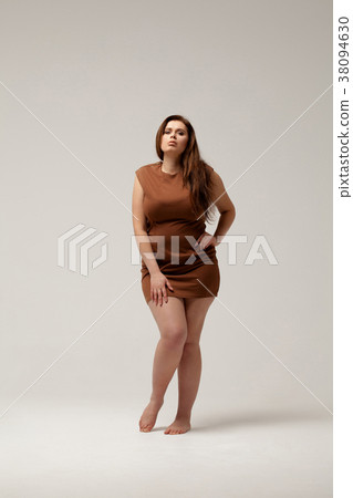 Plus size fashion model in brown short dress 38094630
