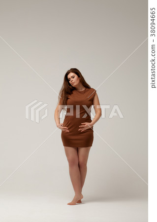 Plus size fashion model in brown short dress 38094665