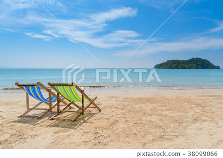 Two beach chairs on the white sand with blue sky Two beach chairs on the white sand with blue sky 38099066