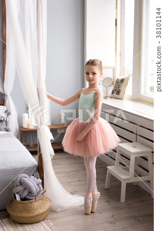 Cute little ballerina in pink ballet costume. 38101144