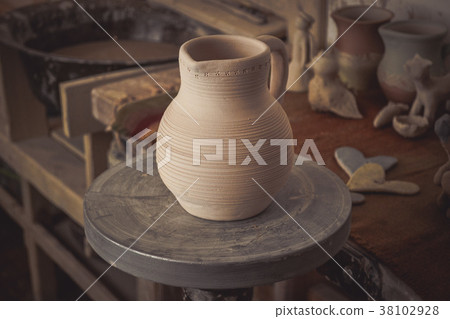 Clay jug on a potter's wheel Clay jug on a potter's wheel 38102928