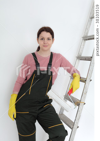 Female worker painting wall in a room Female worker painting wall in a room 38103519