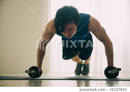 Young Japanese man doing push-ups Young Japanese man doing push-ups 38107691