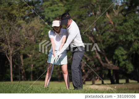 Asian young couple playing golf on golf course Asian young couple playing golf on golf course 38109306