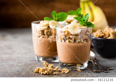 Layered chocolate chia pudding parfait with banana Layered chocolate chia pudding parfait with banana 38111216