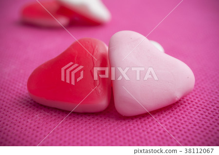 shaped heart candies on pink background 38112067
