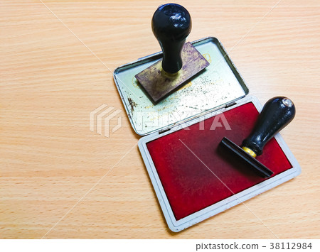 Rubber stamp lying on the wooden table 38112984