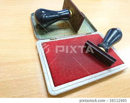 Rubber stamp lying on the wooden table 38112985