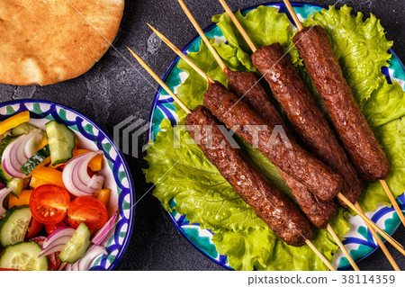 Classic kebabs on the plate. 38114359