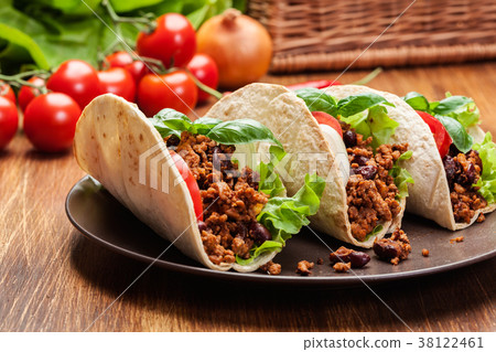 Mexican tacos with minced meat, beans and spices Mexican tacos with minced meat, beans and spices 38122461