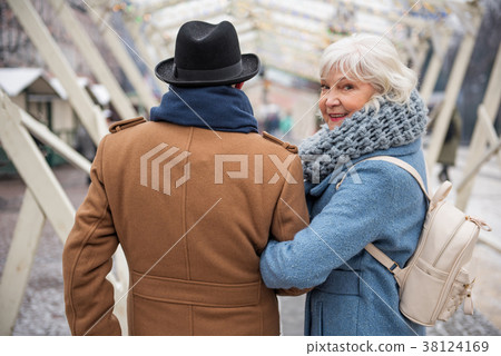 Joyful senior lady enjoying walk with her husband 38124169