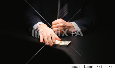 BRIBE: Businessman takes money bundle from table BRIBE: Businessman takes money bundle from table 38124268