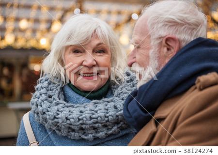 Happy old woman enjoying holiday entertainment Happy old woman enjoying holiday entertainment 38124274