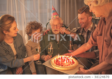 Outgoing relatives congratulate grandpa in room 38124670