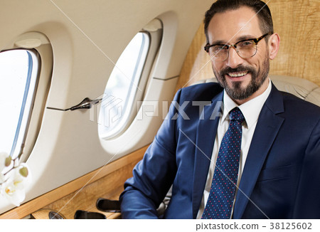 Happy man travelling by modern airliner Happy man travelling by modern airliner 38125602