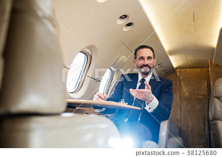 Cheerful male using air transport Cheerful male using air transport 38125680