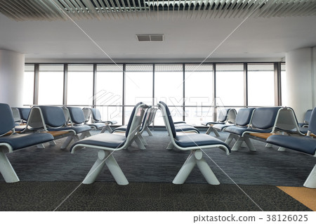 Empty airport terminal waiting area with chairs  38126025