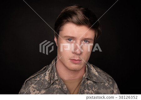 Sad male soldier regretting his past Sad male soldier regretting his past 38126352