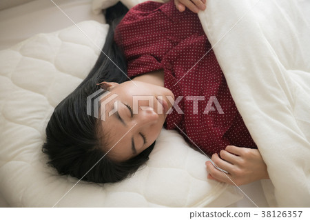 A young Japanese woman sleeping A young Japanese woman sleeping 38126357