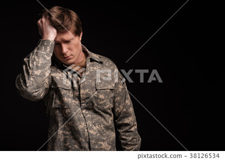 Unhappy male veteran remembering past 38126534