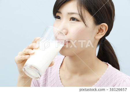 A young lady drinking milk A young lady drinking milk 38126657