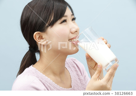 A young lady drinking milk 38126663