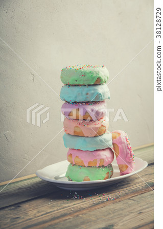 A stack of donuts on wooden table A stack of donuts on wooden table 38128729