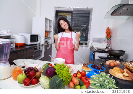 happy woman cooking in kitchen room happy woman cooking in kitchen room 38131968