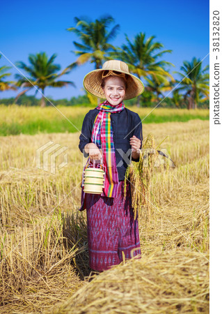farmer woman with tiffin carrier in rice field farmer woman with tiffin carrier in rice field 38132820