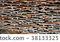 Tiles of different shades are stacked in pile. 38133325