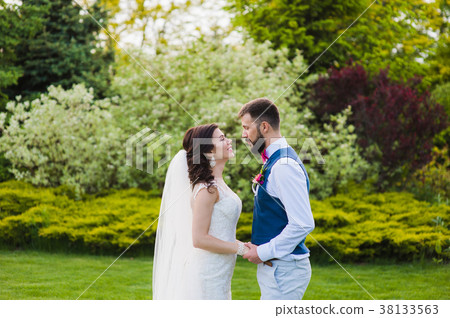 Just married young couple going to kiss Just married young couple going to kiss 38133563