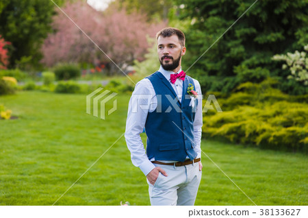 Portrait of serious stylish groom outdoors Portrait of serious stylish groom outdoors 38133627
