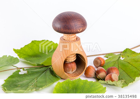Wooden mushroom shape nutcracker and hazelnuts Wooden mushroom shape nutcracker and hazelnuts 38135498