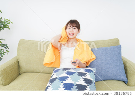 Woman watching TV at home Woman watching TV at home 38136795