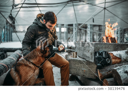Stalker feeding a dog, apocalypse concept 38139476