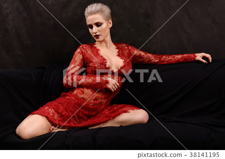 attractive young blond woman in red lace dress  38141195