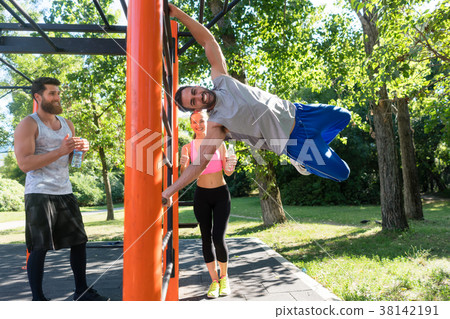 Strong young man practicing human flag exercise Strong young man practicing human flag exercise 38142191