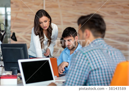 Pleasant young smiling colleagues discussing 38143589