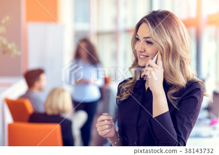 Young attractive businesswoman talking on mobile Young attractive businesswoman talking on mobile 38143732